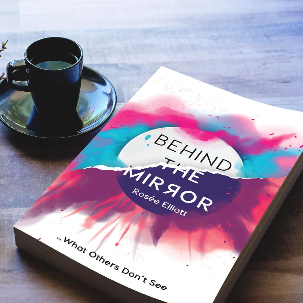 Copy of behind the mirror book by Rosie ELLIOTT on table with coffee cup